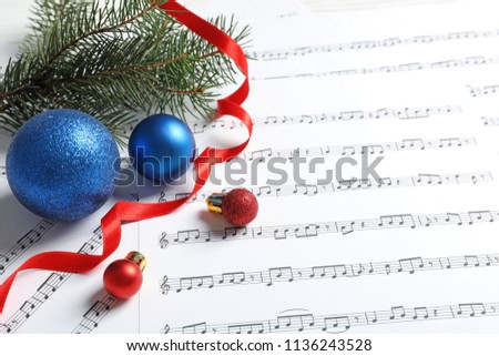 Composition with Christmas decorations on music sheets