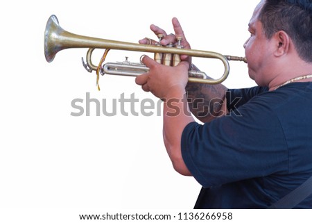 The trumpeter is playing on a silver trumpet. Trumpet player old.