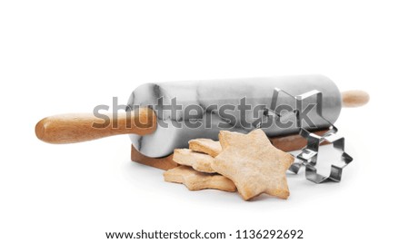 Tasty homemade Christmas cookies, cutters and rolling pin on white background