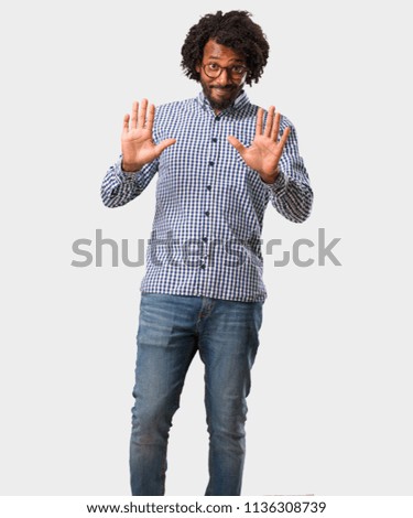 Handsome business african american man serious and determined, putting hand in front, stop gesture, deny concept