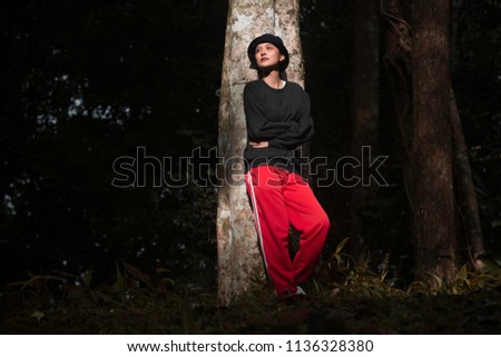 Portrait of hipster Asian woman in the tropical jungle, Thailand.