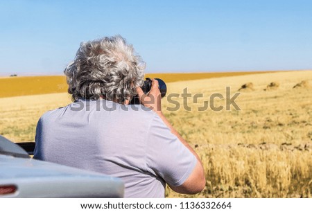 The photographer takes pictures of the landscape