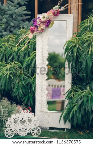 Decor. A white large mirror on a green background