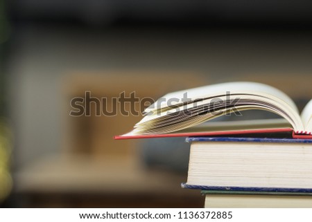 Close-up open vintage book on stack books background. Back to school concept with copy space. Books background for display your work.