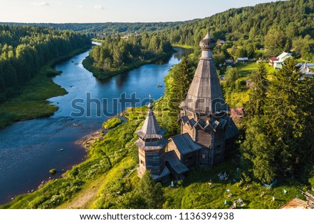 Bird's eye view of the Church of St. Nicholas (built 1696) in Soginicy village and Vazhinka river, Podporozhysky district. Green forests of Leningrad region and Republic of Karelia, Russia. Royalty-Free Stock Photo #1136394938
