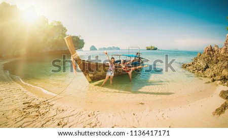 Two happy woman traveling by boat and enjoying the sun. Koh Hong, Thailand