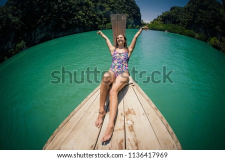 Happy woman traveling by boat and enjoying the sun. Koh Hong, Thailand