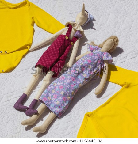 Baby yellow bodysuit, baby clothes and dolls on the white cloth, clothes for babies, yellow jacket small size for sale, handmade dolls for children