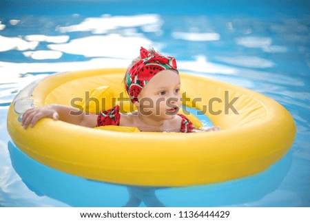 Cute baby learning how to swim