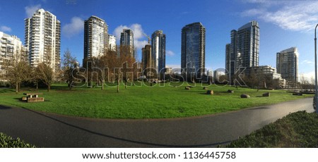 A collection of residential high rises surrounding a park in Vancouver, BC.