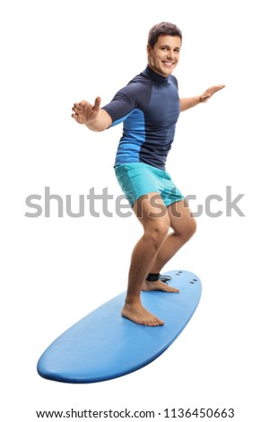 Full length portrait of a surfer surfing on a surfboard isolated on white background Royalty-Free Stock Photo #1136450663