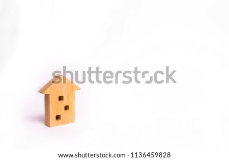 Wooden figure of a multi-storey house on a white background. Three-story house. Buying and selling of real estate, construction. Apartments and apartments. Minimalism. for presentations.