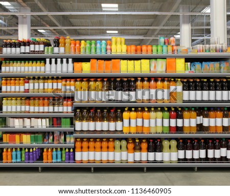 Various bottles of juice, soda, water, vitamins on shelf at supermarket Royalty-Free Stock Photo #1136460905