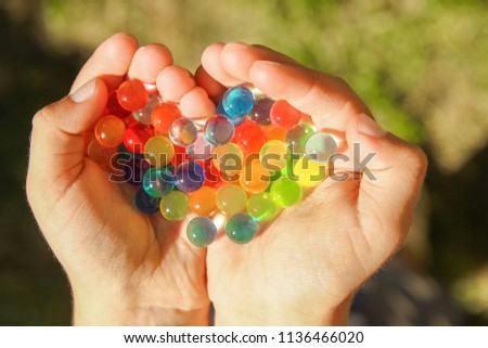 nice background of different colors balls in hands