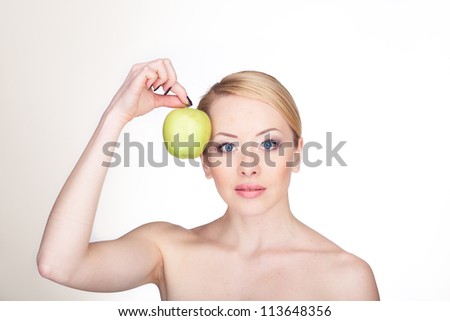 bright closeup portrait picture of beautiful woman with green apple