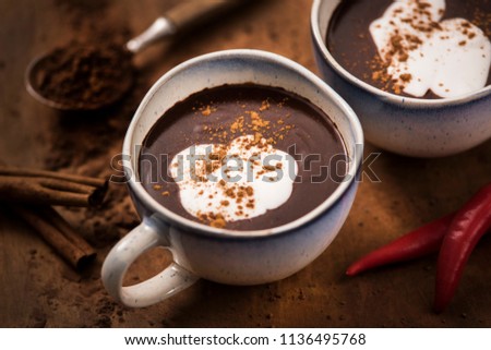 For better humor. A delicious and aromatic cup of hot chocolate with velvet coconut cream, enriched with chilli.