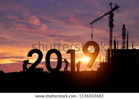 Silhouette staff works as a team to prepare to welcome the new year 2019. Royalty-Free Stock Photo #1136503682