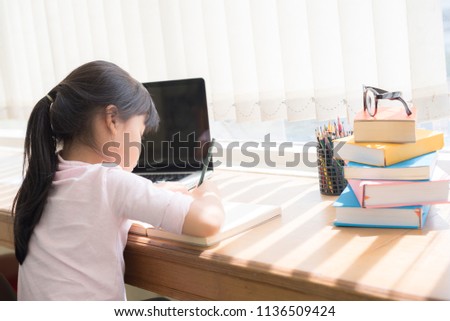 Girl sitting at her desk in the room.