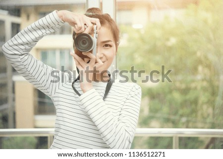 Closeup of beautiful woman taking photo with happy. Hobby and lifestyle people in the city.