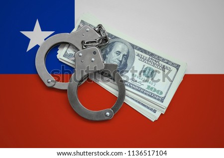 Chile flag  with handcuffs and a bundle of dollars. Currency corruption in the country. Financial crimes