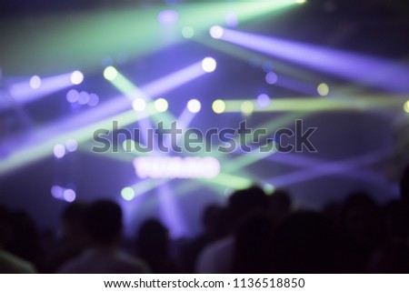 Abstract Background Party Concert Concept. Party people concept. Crowd happy and joyful in club. Celebration, festival, haplessness. Blurry night club.show concert  EDM on stage Bangkok Thailand.