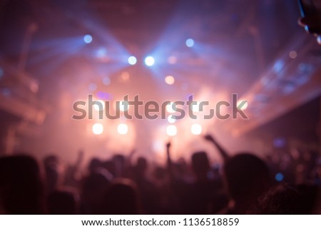 Abstract Background Party Concert Concept. Party people concept. Crowd happy and joyful in club. Celebration, festival, haplessness. Blurry night club. event show concert  EDM on stage 