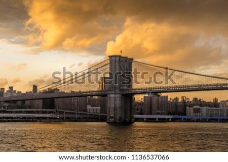 Sunset view of Brooklyn Bridge on East River, NYC