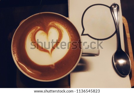 Hot cappuccino coffee with heart shape coffee art.