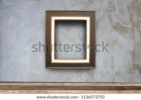 Close up blank photo frame on wooden table with copy space at the living room.