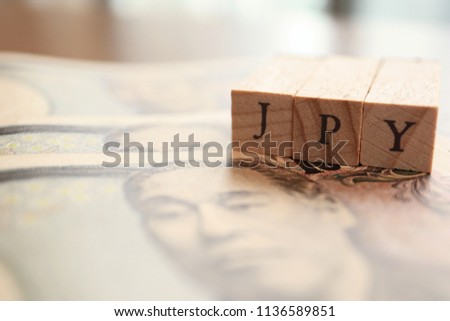 JPY (Japanese Yen) Text Block on Wooden Table