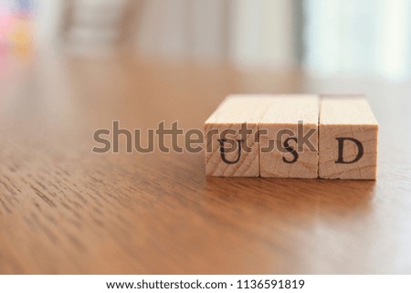 USD (US Dollar) Text Block on Wooden Table