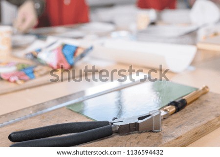 Closeup photo of different devices for making mosaic on table