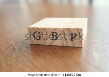 GBP (Great Britain Pound) Text Block on Wooden Table