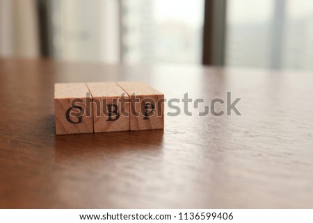 GBP (Great Britain Pound) Text Block on Wooden Table