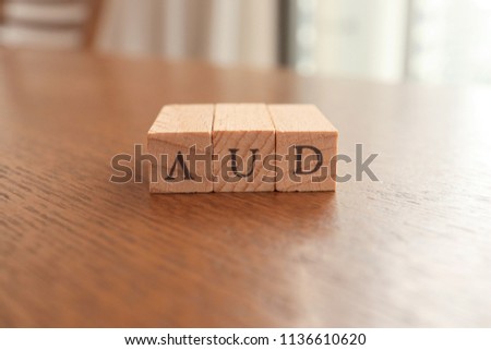 AUD (Australian Dollar) Text Block on Wooden Table