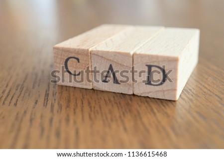 CAD (Canadian Dollar) Text Block on Wooden Table