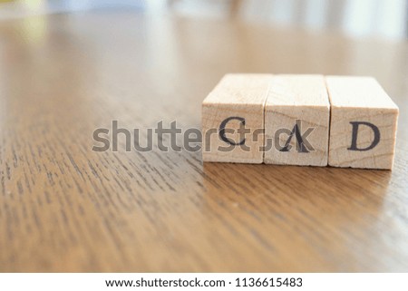 CAD (Canadian Dollar) Text Block on Wooden Table