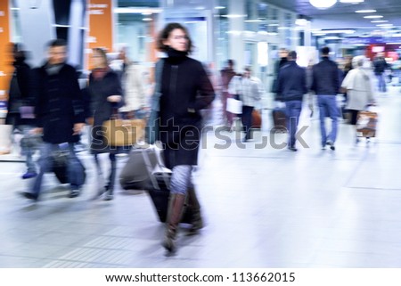 People walking against the light background of an urban landscape. Motion blur.