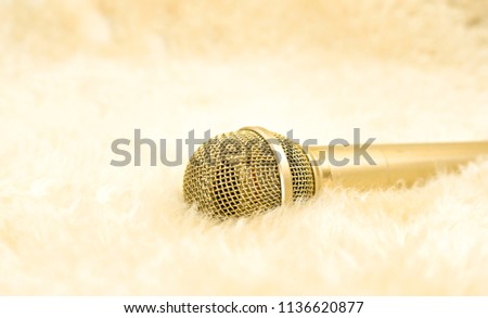 Gold microphone on wool carpet.  Luxury concept