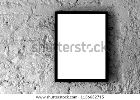 Blank mock up picture frame of vertical street poster billboard on a gray colored stone wall. Copy space for text area.