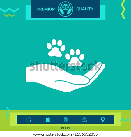 Hand holding paw symbol. Animal protection