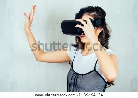 Indian girl with virtual reality glasses is very surprised