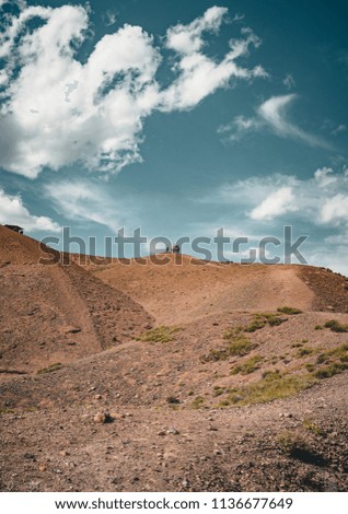 Charyn Grand Canyon with clouds and sun red orange stone Martian landscape