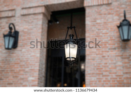 Brick wall building with light lamp, stock photo