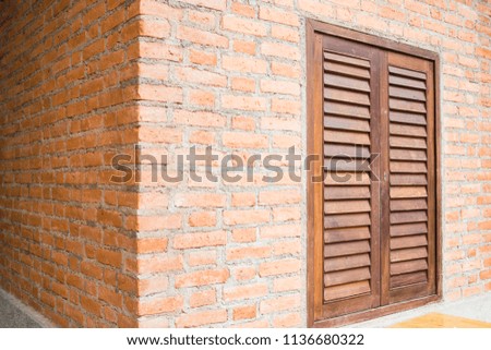 Brick wall building with wooden window, stock photo