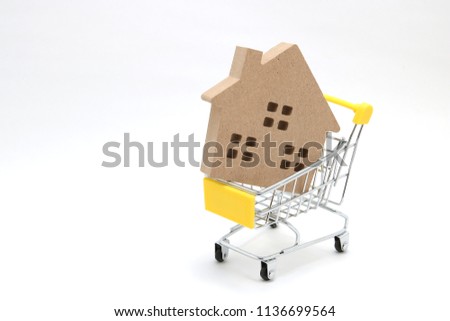 
Shopping cart and house on white background.
Buying new house, real estate and home mortgage concept.
