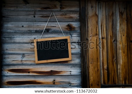 Blackboard on the wood wall.