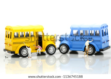 Miniature people: Workers brush painting school bus,Back to school concept.