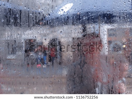Rain drops on the window. Abstraction of a street in the rain
