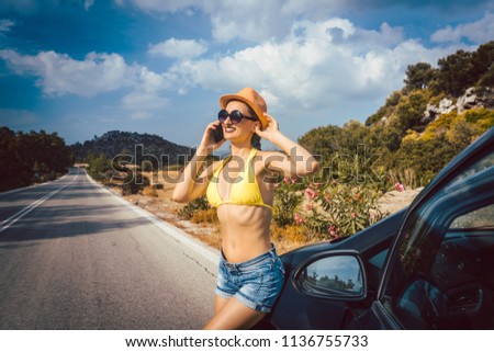 Woman using phone in her vacation to call friends